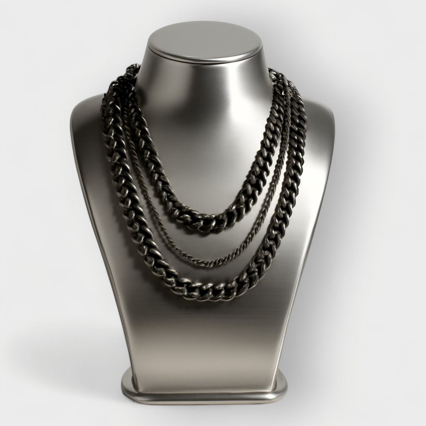 Black aluminium and metal chain necklace on a metallic mannequin bust against a white background