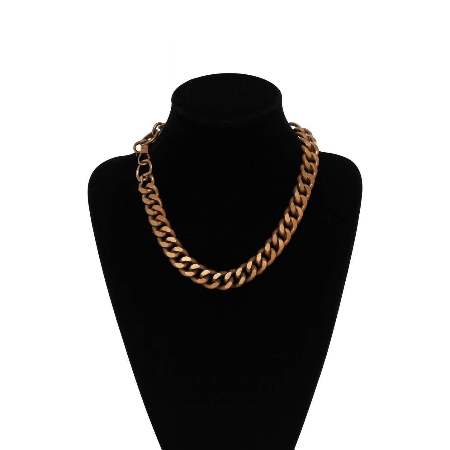Gold chain necklace on a black mannequin bust against a white background
