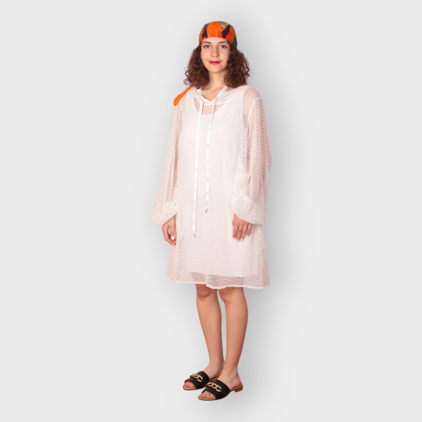 Women is wearing a UK12/ US10  Aphrodite White Holiday Resort Dress with matching white undergarment and hoodie  Short Version photographed from the front.