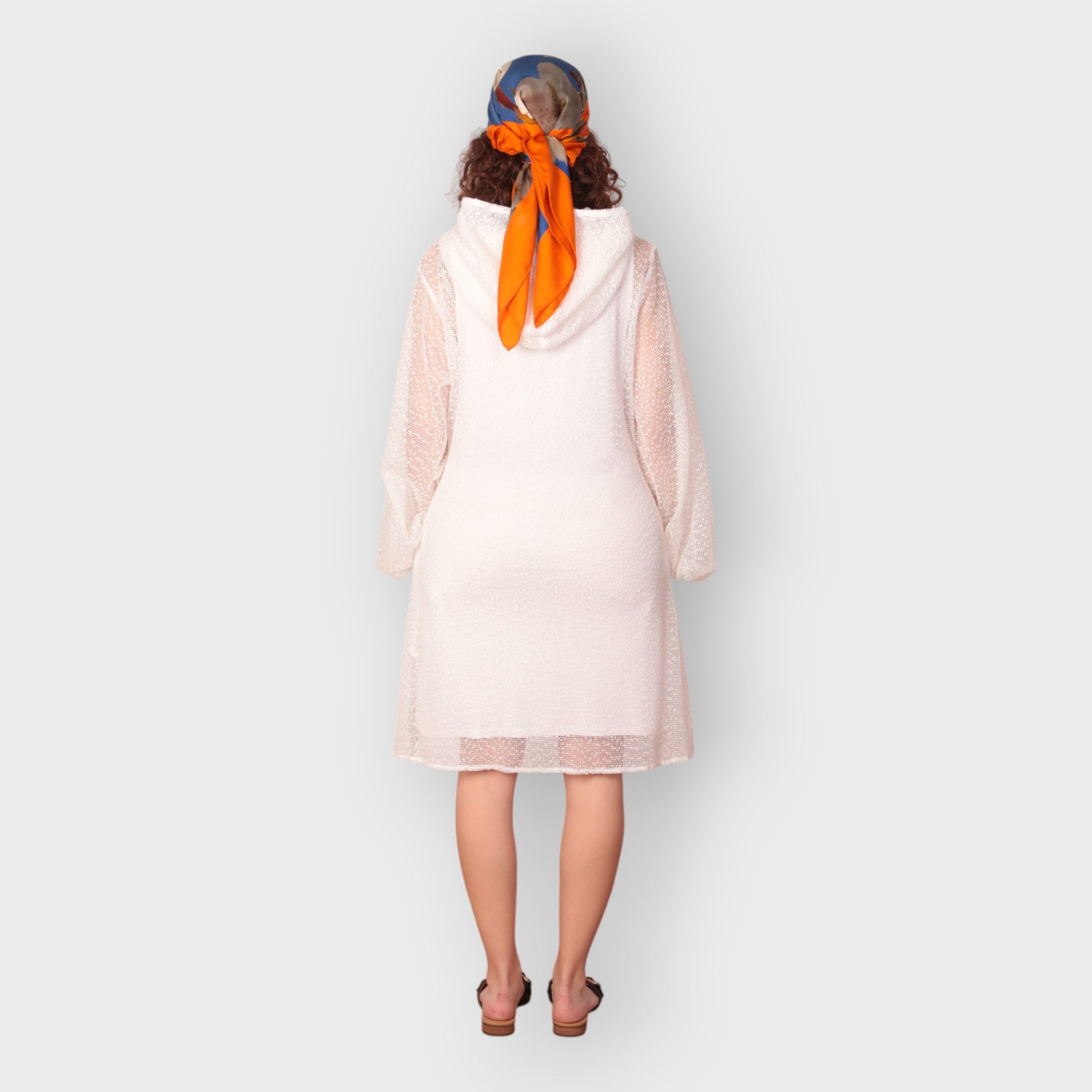 Women is wearing a UK12/ US10  Aphrodite White Holiday Resort Dress with matching white undergarment and hoodie  Short Version photographed from the back.