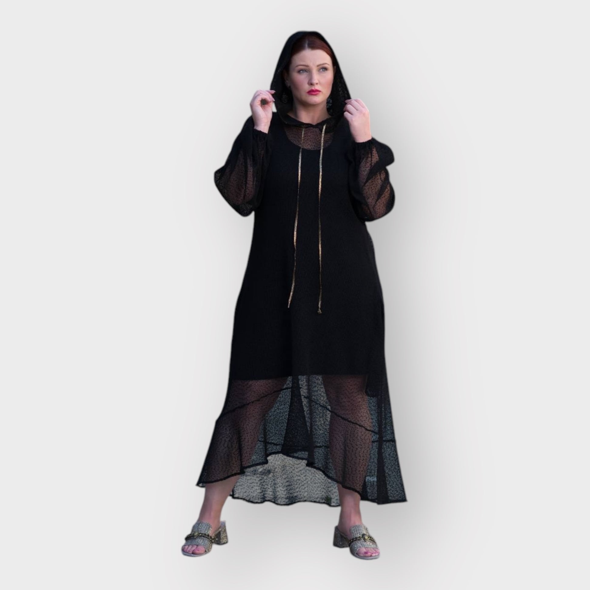 Plus Size Aphrodite Black Holiday Resort Dress with hoodie and black undergarment, styled with golden sandals for a chic and comfortable look.