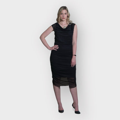 Women's Boudicca Summer Black Ruched Bodycon dress styled with a silver necklace and black heels for an elegant, sophisticated look.