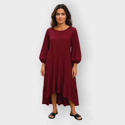 Mid Size Woman wearing a red burgundy Leopard dress against a white background