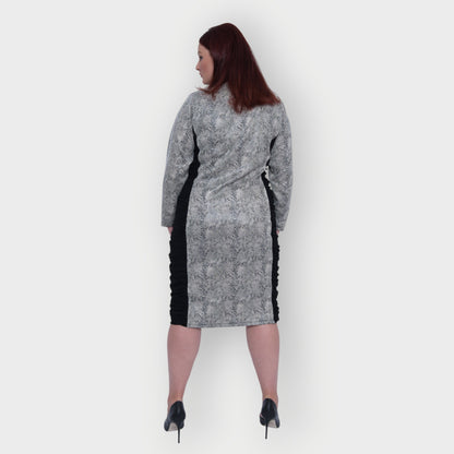 Women's Plus Size Black White Animal Print Bodycon Midi Vegan Leather Dress shown from the back, styled with black heels for a chic look.White Background.
