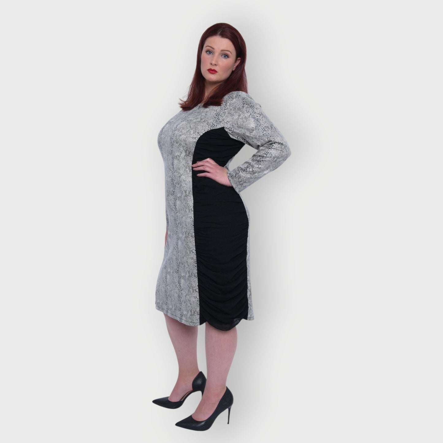 Women's Plus Size Black White Animal Print Bodycon Midi Vegan Leather Dress shown from the side, styled with black heels for a chic look.White Background.