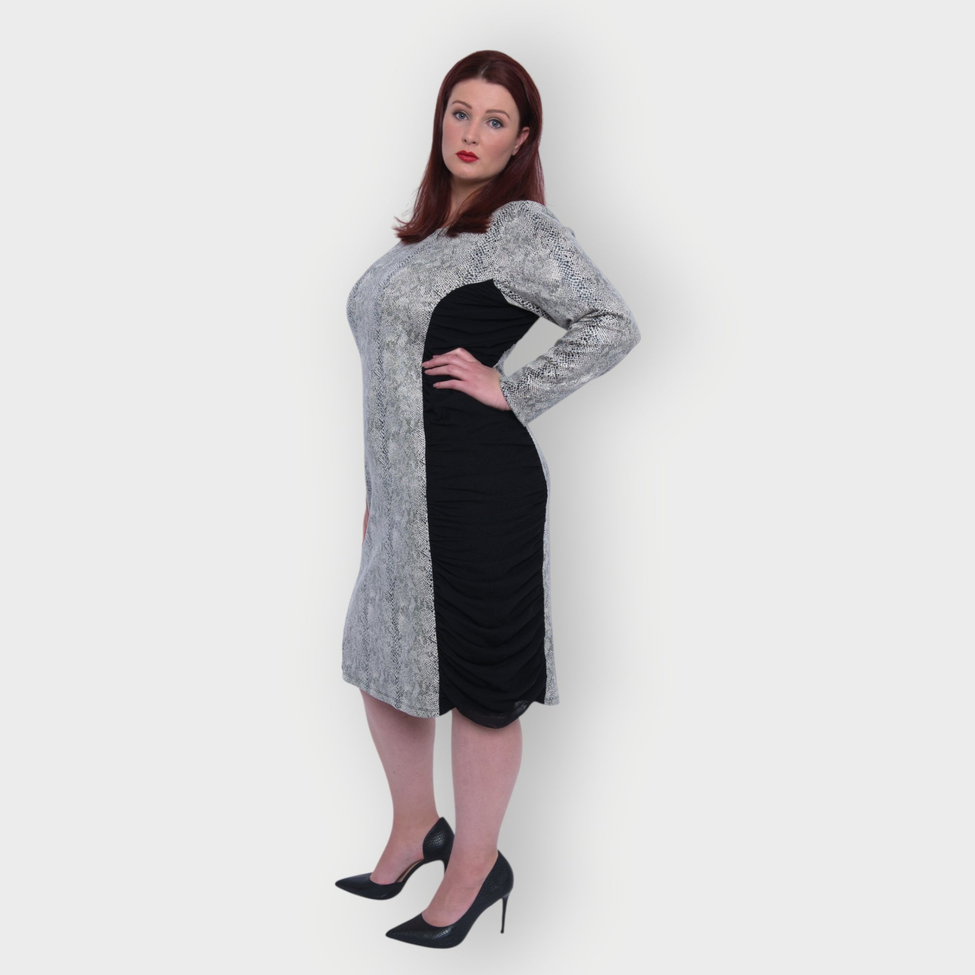 Women's Plus Size Black White Animal Print Bodycon Midi Vegan Leather Dress shown from the side, styled with black heels for a chic look.White Background.