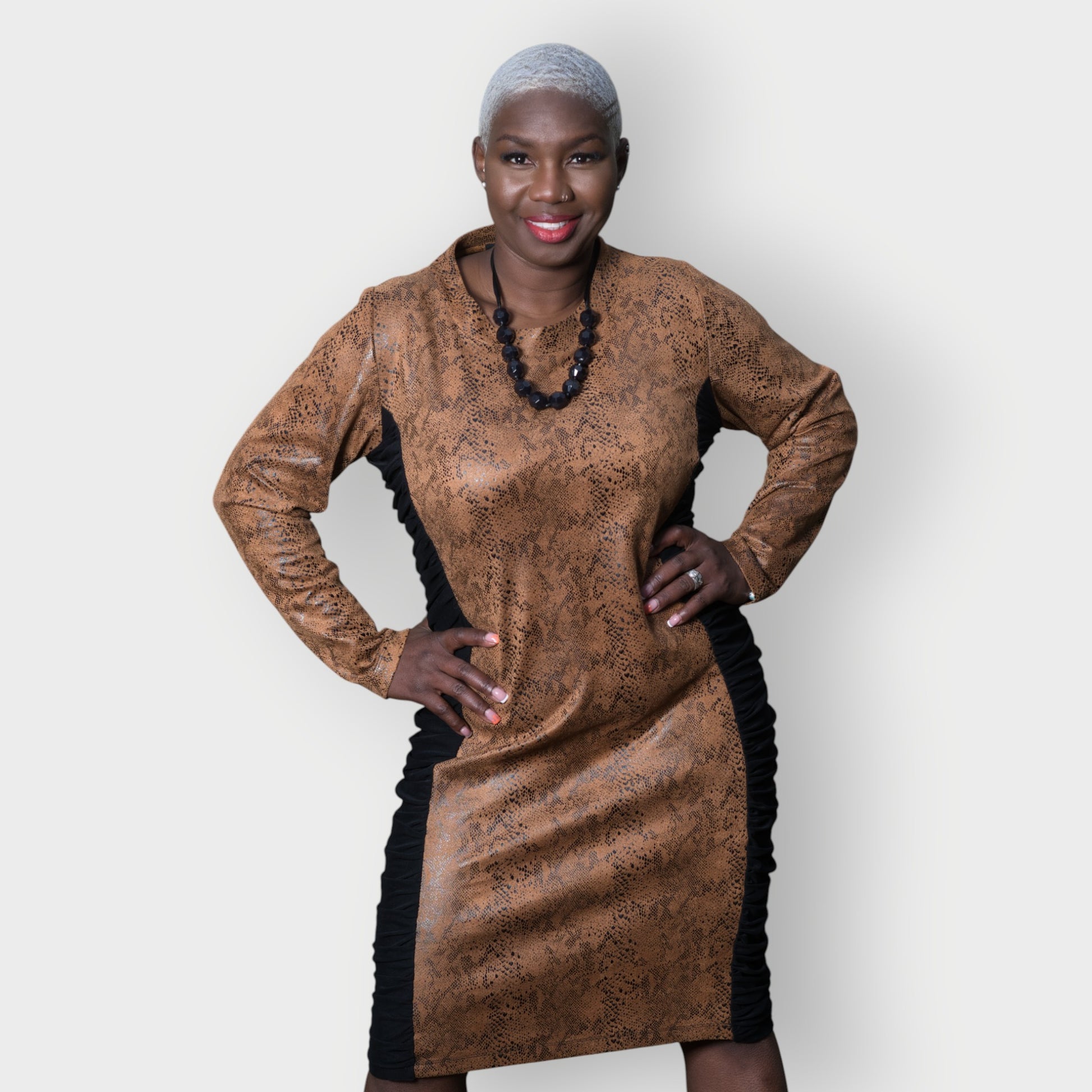 Women's Plus Size Black Brown Animal Print Bodycon Midi Vegan Leather Dress styled with a black necklace.White Background.