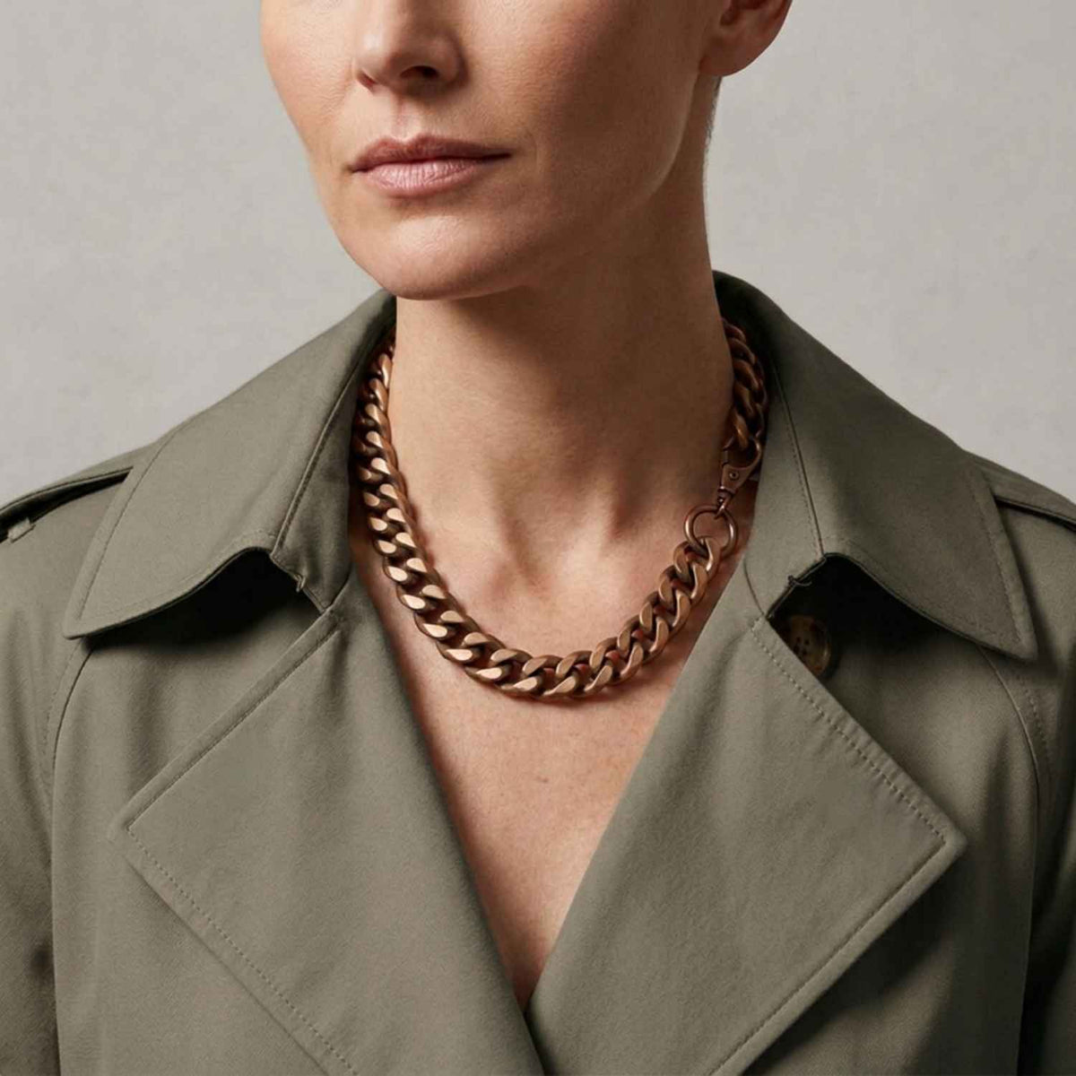 Gold Aluminium Chain necklace with model wearing an olive green trench coat