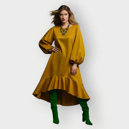 Woman wearing a mustard yellow dress with green boots on a white background