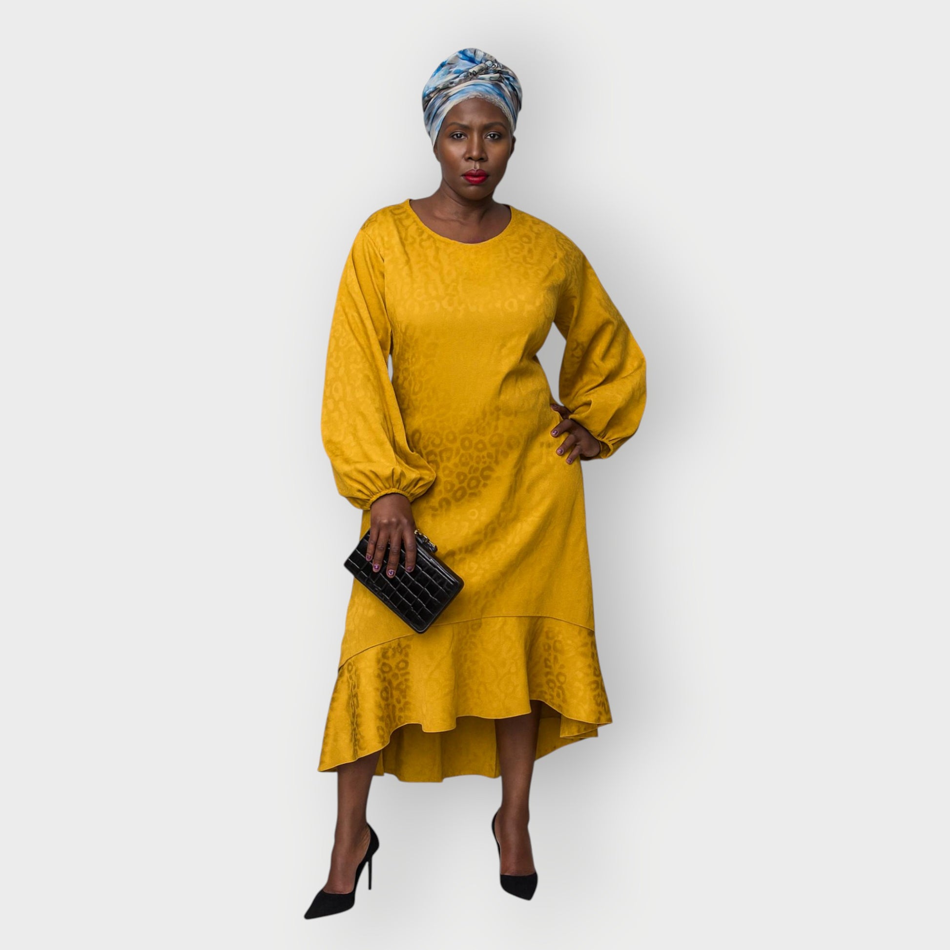 Women's Plus Size Gold Aphrodite Leopard Jacquard Dress styled with a  black clutch, and black heels for an elegant look.
