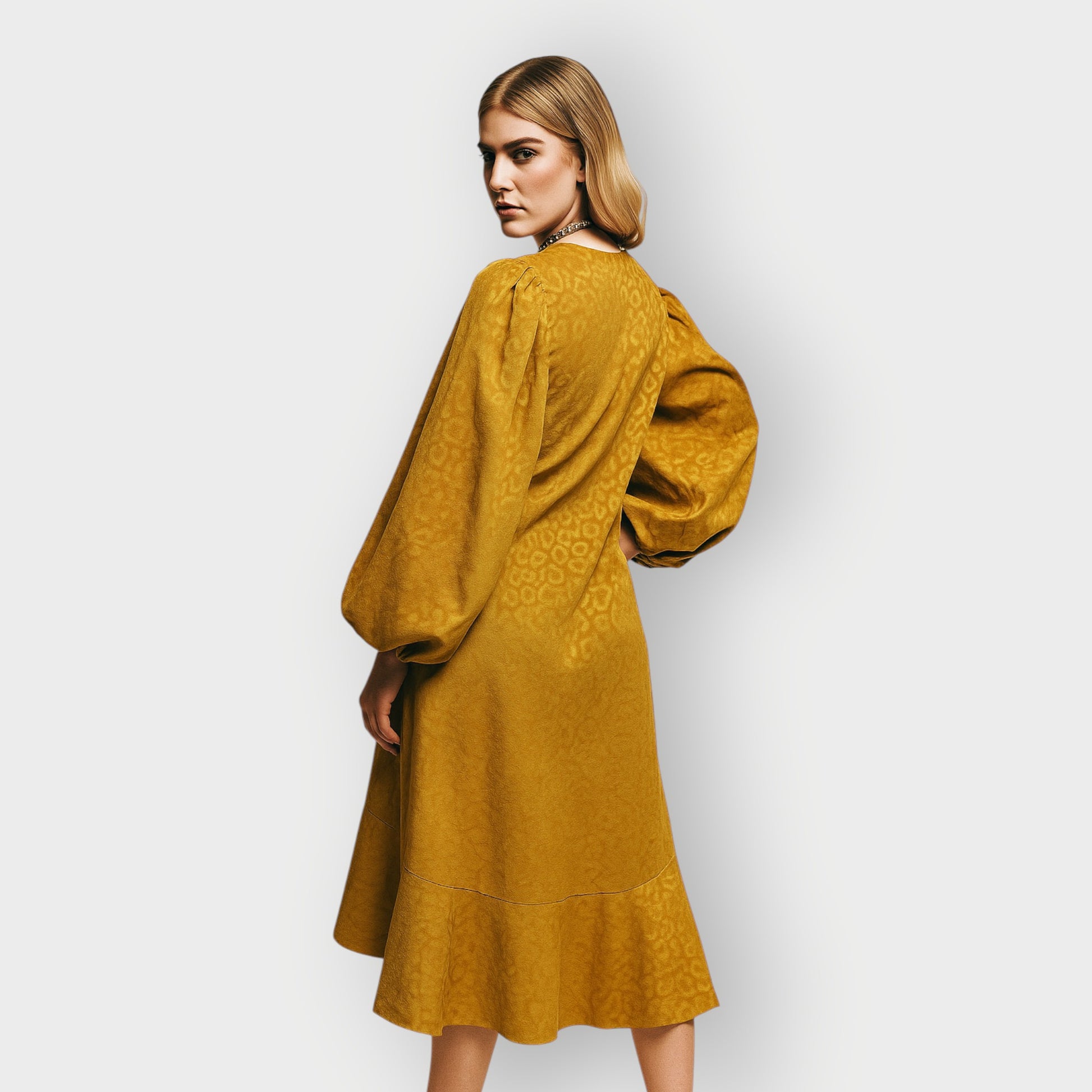 Woman wearing a mustard yellow dress against a white background
