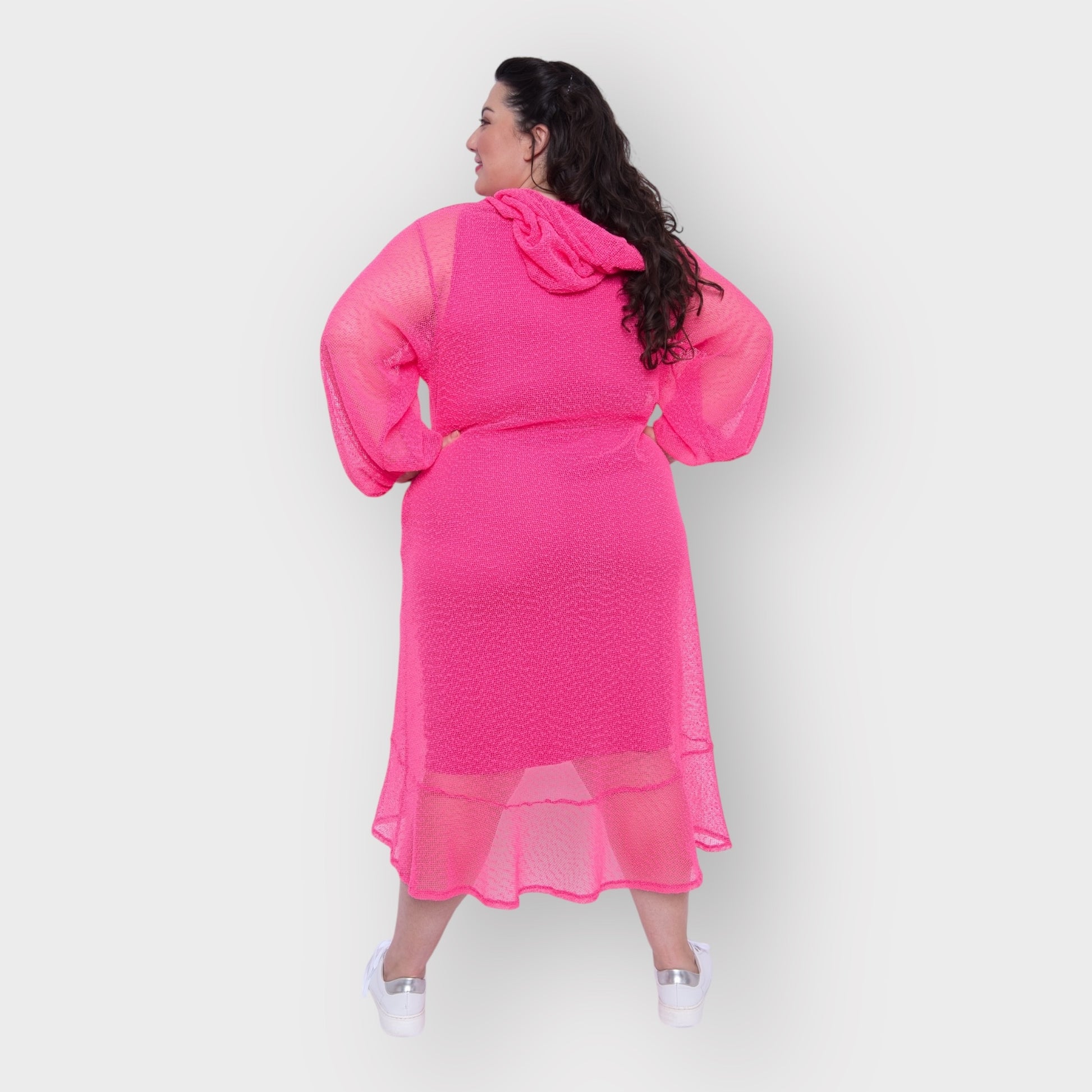 Women's Plus Size Aphrodite Hot Pink Holiday Resort Dress with hoodie and hot pink undergarment, paired with white sneakers for a relaxed look.