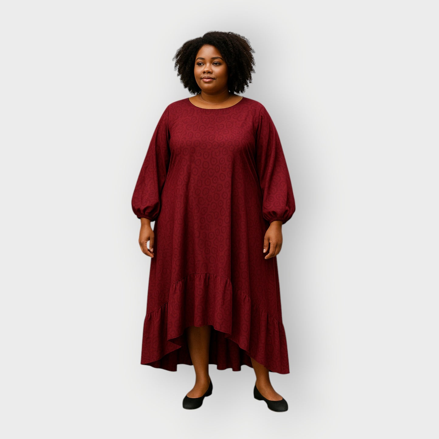 Woman wearing a burgundy dress with puff sleeves on a white background