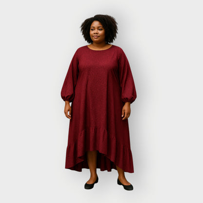 Woman wearing a burgundy dress with puff sleeves on a white background