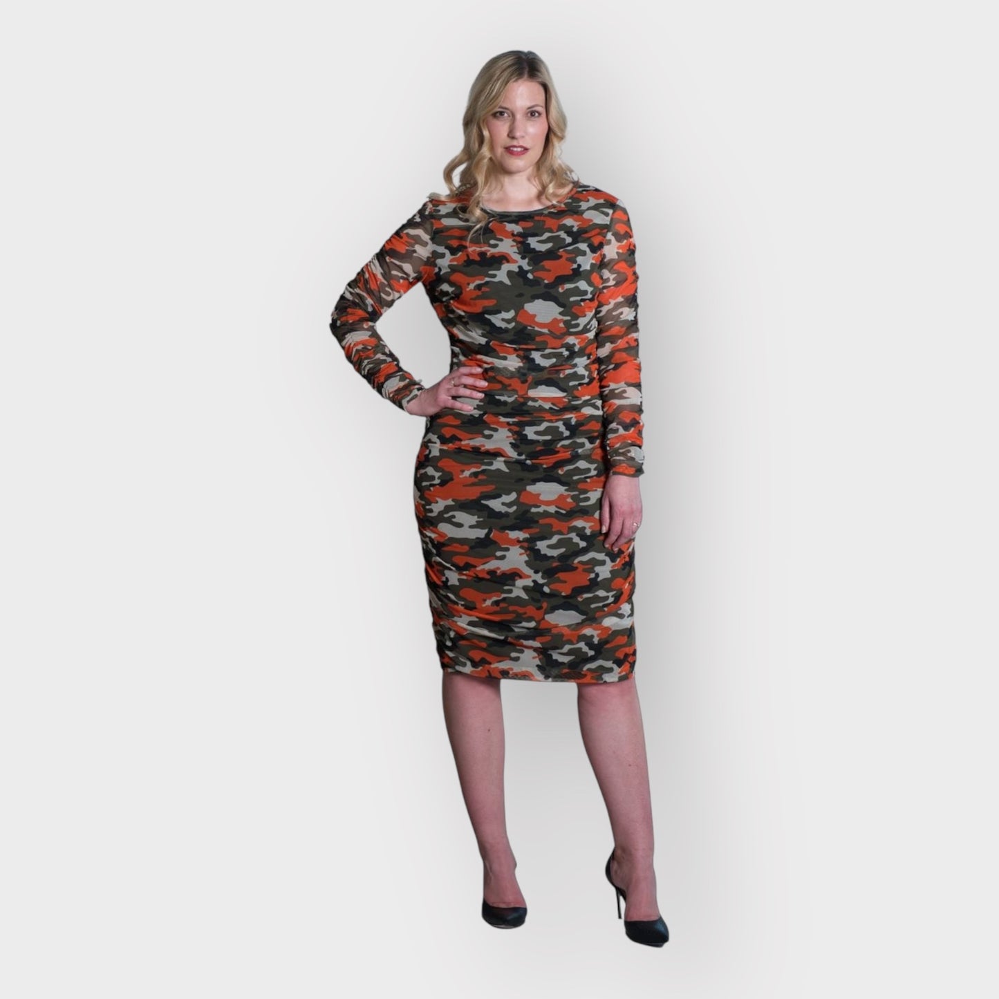 Women's Mid Size Orange Green Grey Camouflage Bodycon Midi Dress styled with black heels for a modern, stylish look.