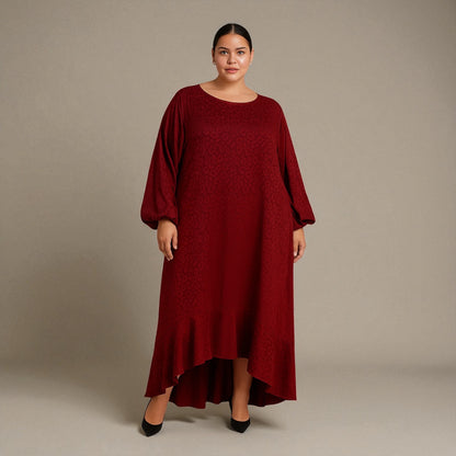 Plus Size Woman wearing a red burgundy Leopard dress against a plain background