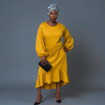 Women's Plus Size Gold Aphrodite Leopard Jacquard Dress styled with a  black clutch, and black heels for an elegant look.Plain Background.