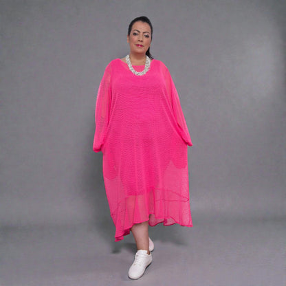 Women's Aphrodite Plus Size Hot Pink Holiday Resort Dress with a hot pink undergarment shown, paired with a white necklace and white sneakers