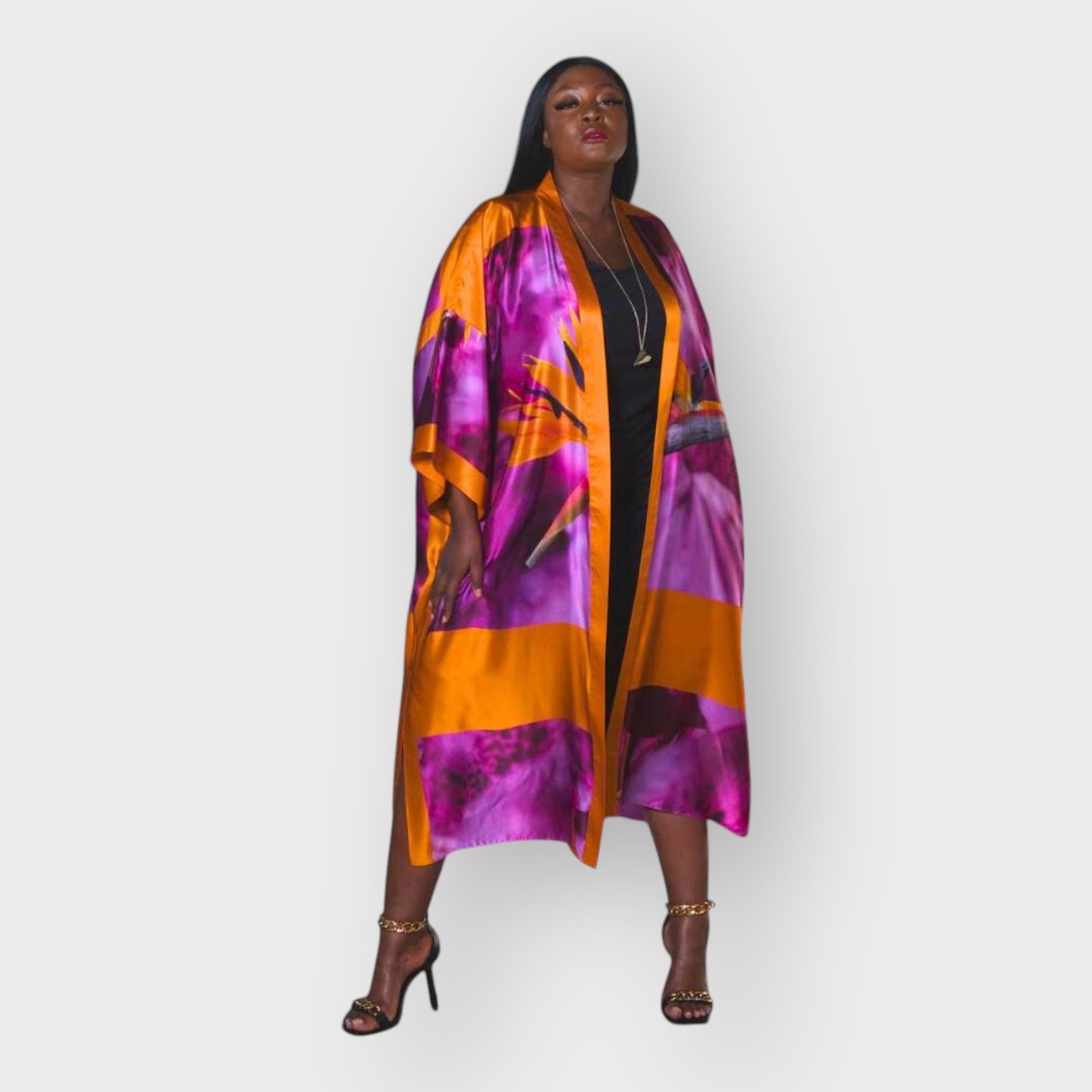 Women's Bird of Paradise Pink Purple Plus Size and Mid Size Silk Kimono styled with the Boudicca Black Dress and gold chain heels for an elegant look.
