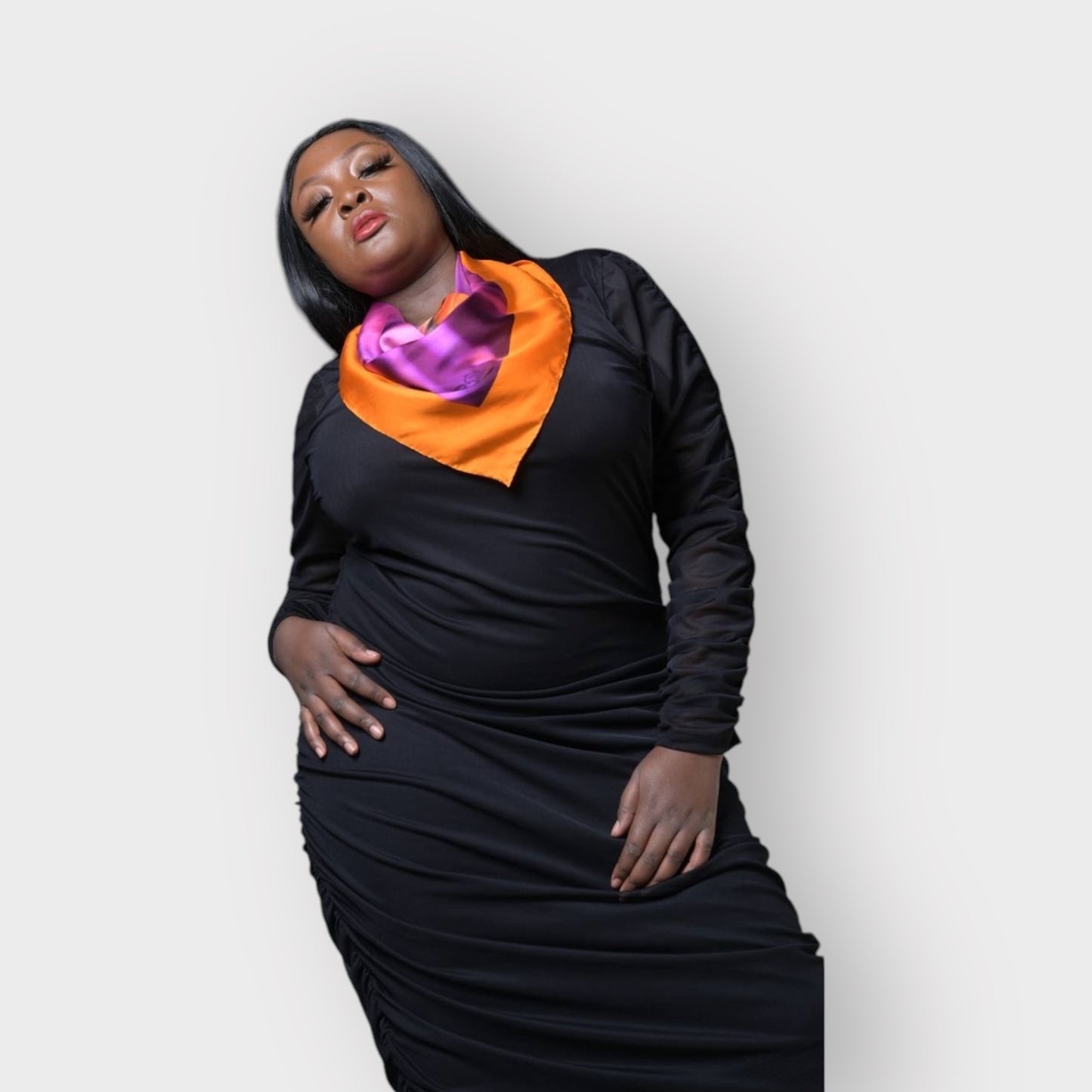Silk scarf with Orange Bird of Paradise and Pink and Purple print, styled elegantly around model's neck over the Boudicca Black Plus Size Ruched Bodycon Dress.White Background.