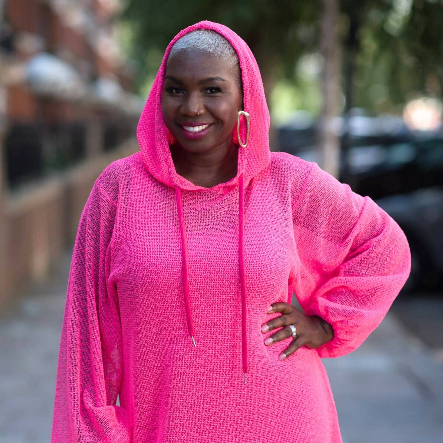 Women's Plus Size Aphrodite Hot Pink Holiday Resort Dress with matching hot pink undergarment and hoodie, styled with golden earrings.