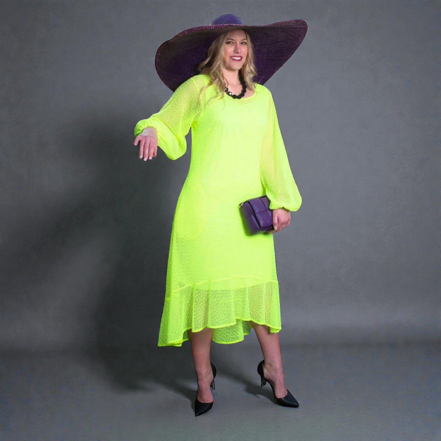 Women's Aphrodite Neon Lime Holiday Resort Dress with matching neon lime undergarment, styled with a purple sunhat, handbag, and black heels.