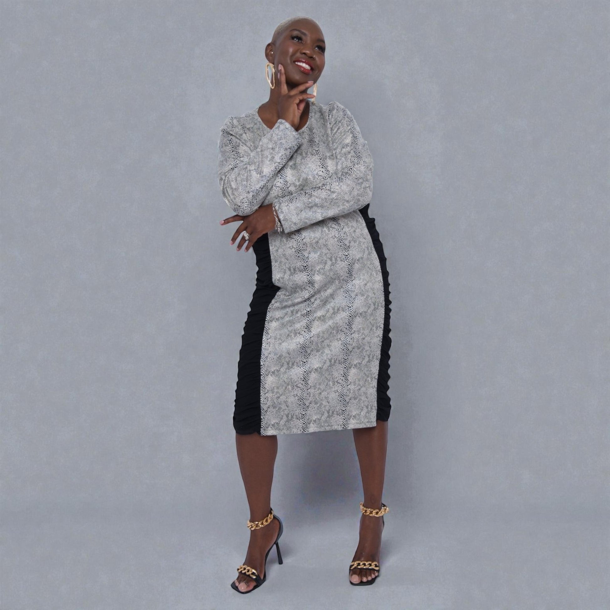 Women's Plus Size Black White Animal Print Bodycon Midi Vegan Leather Dress styled with a red Michael Kors handbag and black heels for an elegant look.