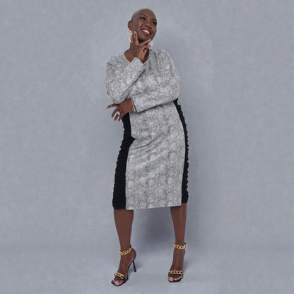 Women's Plus Size Black White Animal Print Bodycon Midi Vegan Leather Dress styled with a red Michael Kors handbag and black heels for an elegant look.