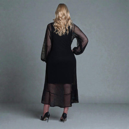 Women's Aphrodite Black Holiday Resort Dress with black undergarment, accessorized with black heels.