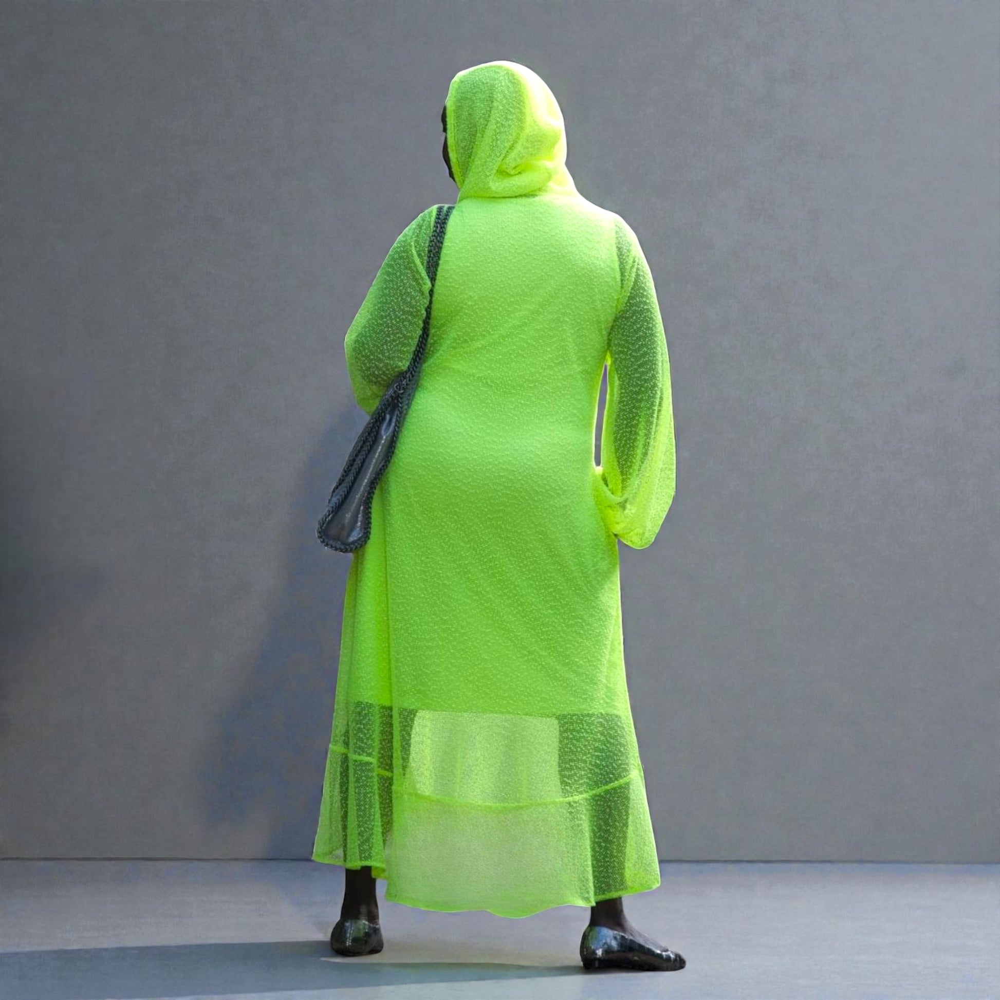 Women's Plus Size Aphrodite Neon Lime Holiday Resort Dress with hoodie and matching neon lime undergarment, styled with a silver  handbag and silver flats.