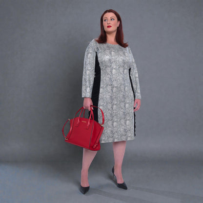 Women's Plus Size Black White Animal Print Bodycon Midi Vegan Leather Dress styled with a red Michael Kors handbag and black heels for an elegant look.