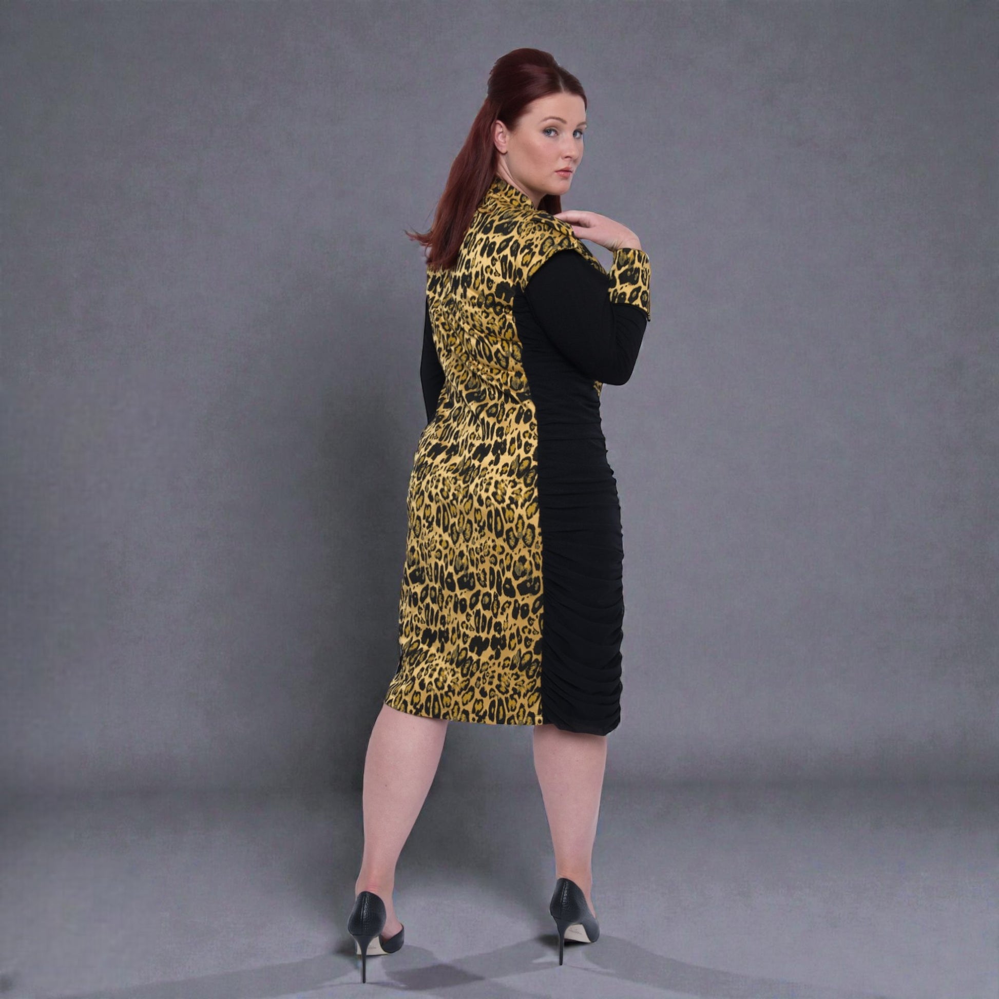 Women's Plus Size Black Gold Leopard Brocade Jacquard Midi Dress styled with black heels for an elegant, polished look. Grey Background.