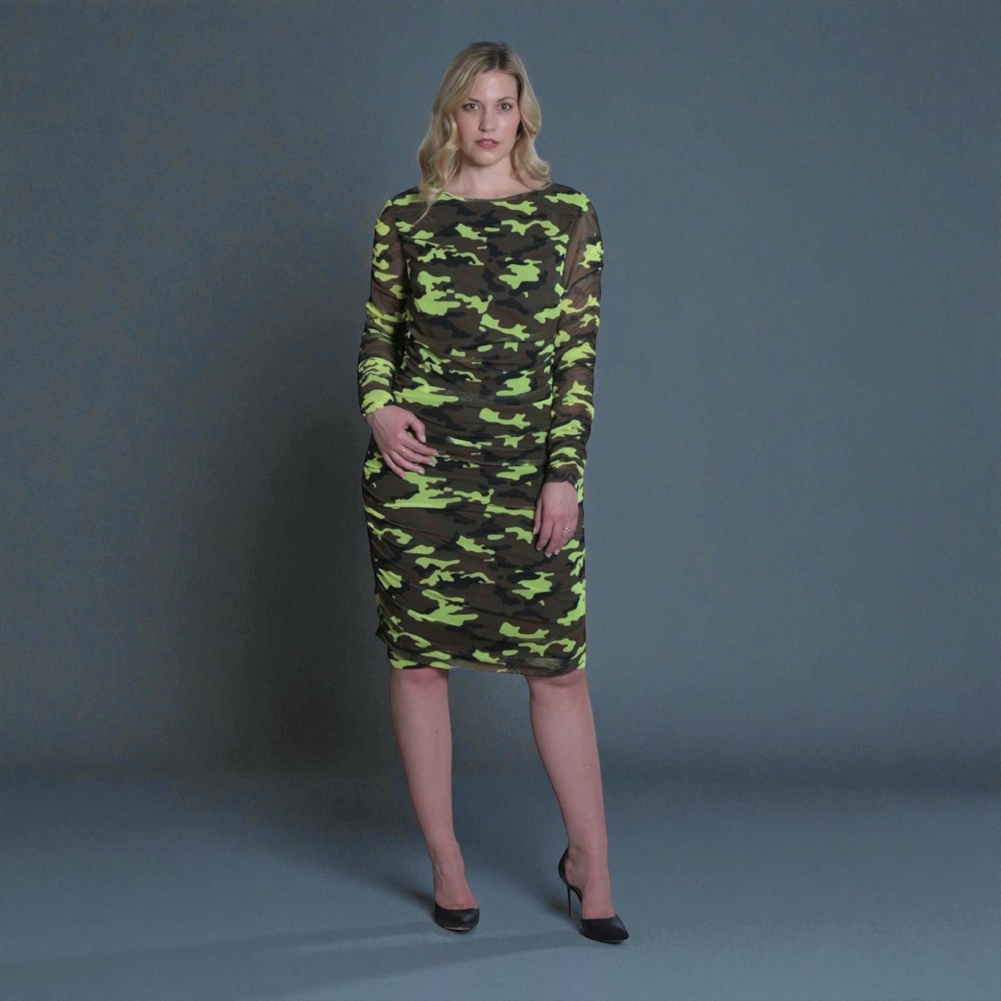 Women's Mid Size Neon Lime Brown Black Camouflage Bodycon Midi Dress styled with black heels for a bold and chic look.Grey Background.