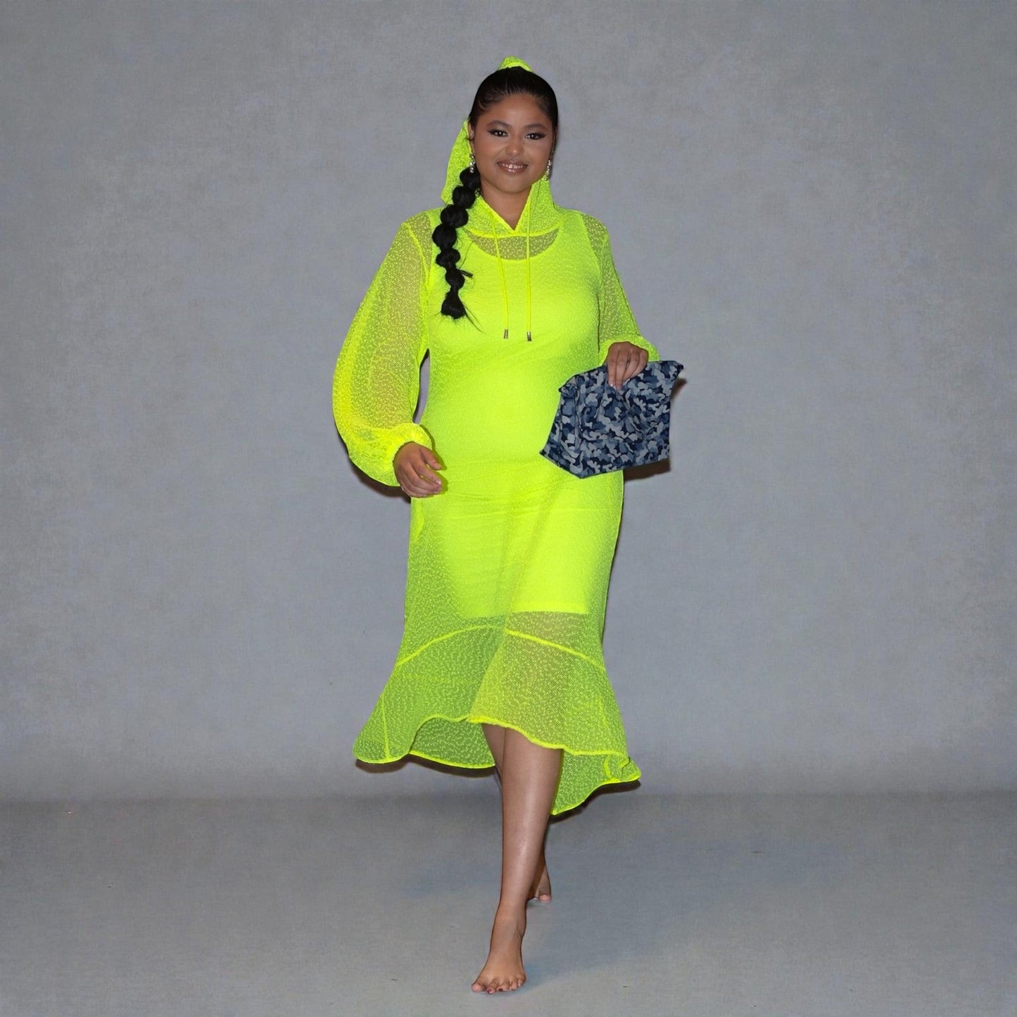 Women's Plus Size Aphrodite Neon Lime Holiday Resort Dress with hoodie and matching neon lime undergarment, styled with a blue camouflage bag.