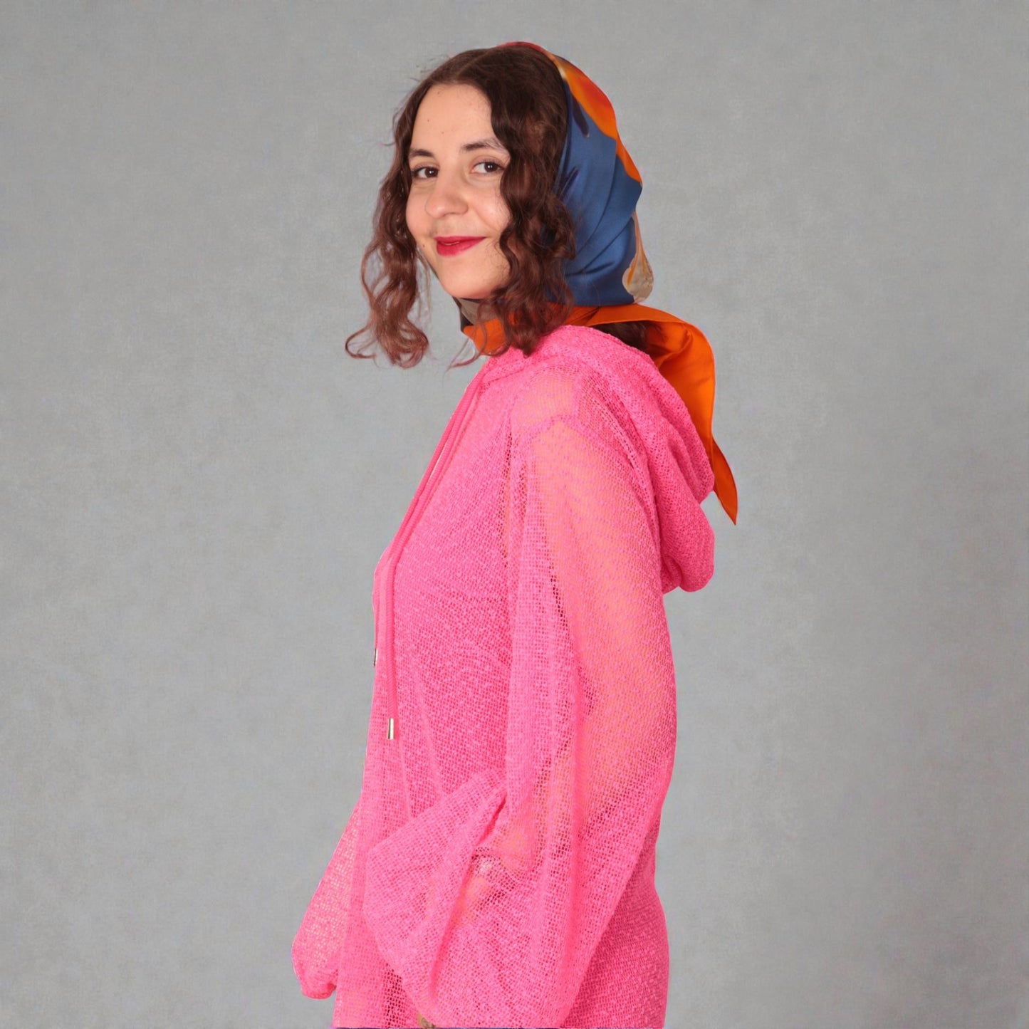 Women is wearing a UK12/ US10  Aphrodite Hot Pink Holiday Resort Dress with matching pink undergarment and hoodie  Short Version photographed from the side.