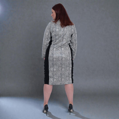 Women's Plus Size Black White Animal Print Bodycon Midi Vegan Leather Dress shown from the back, styled with black heels for a chic look.Grey Background.