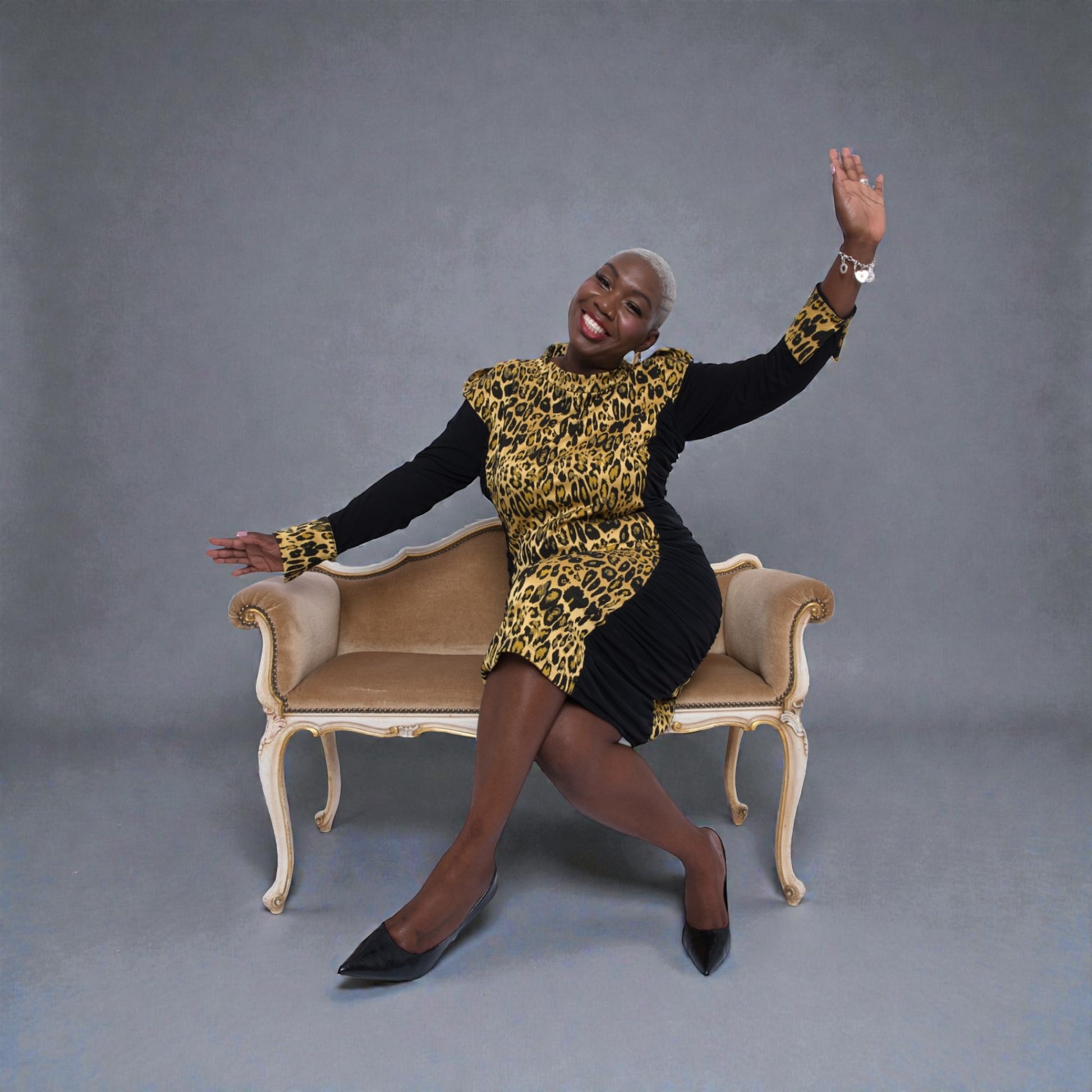 Women's Plus Size Black Gold Leopard Brocade Jacquard Midi Dress styled with black heels for an elegant, polished look. Grey Background.