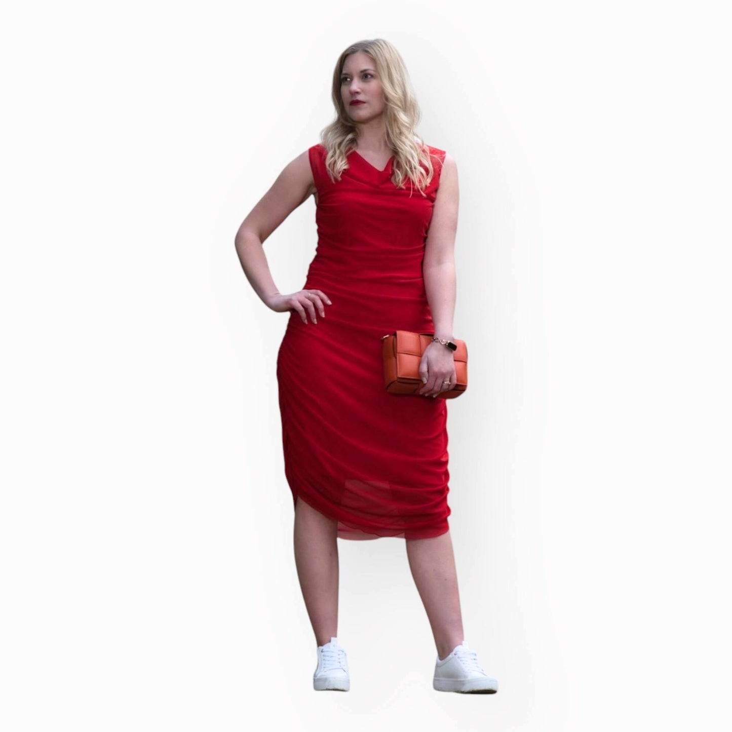 Women's Boudicca Summer Red Ruched Bodycon Midi Dress styled with an orange handbag and white sneakers for a chic, modern ensemble.