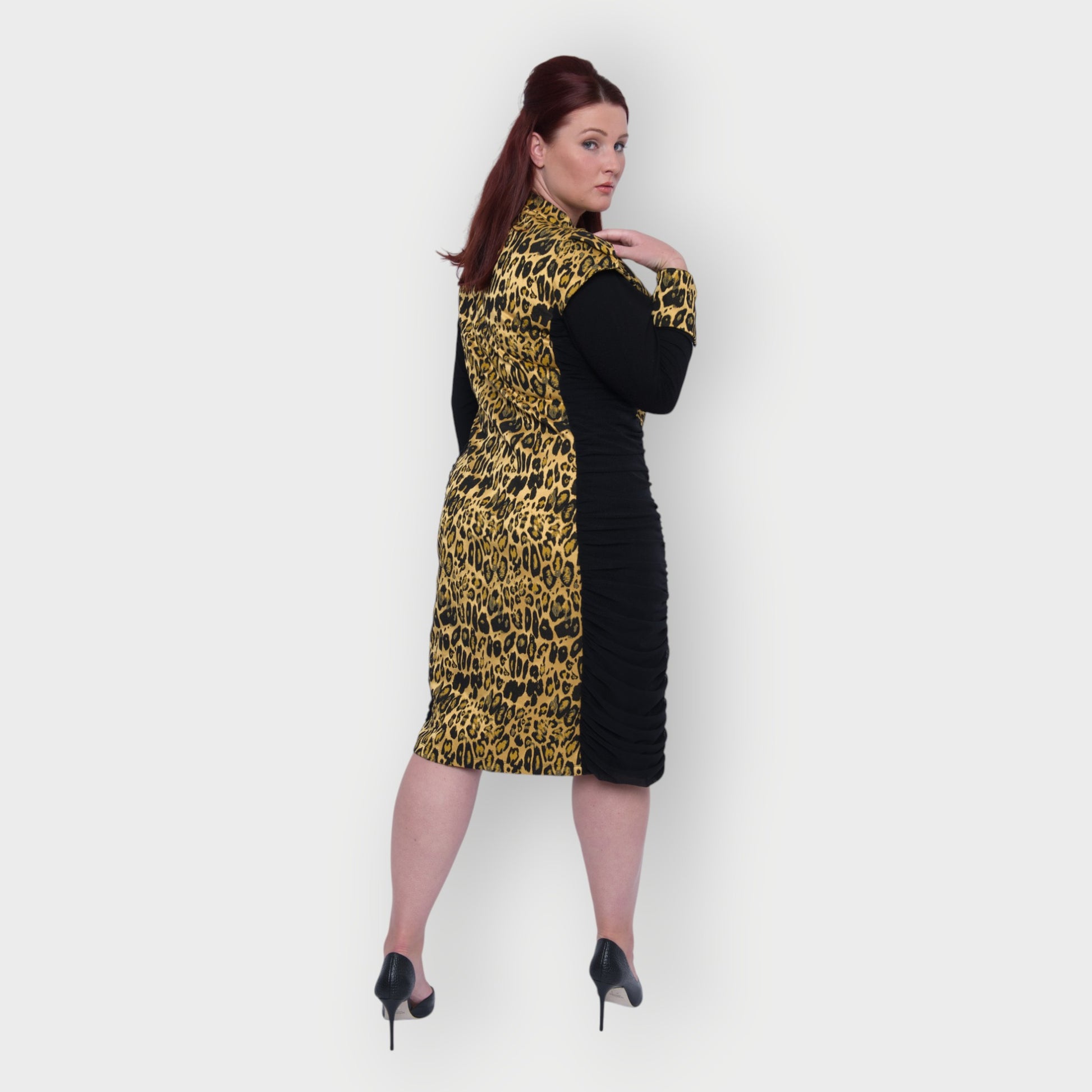 Women's Plus Size Black Gold Bodycon Midi Leopard Brocade Jacquard Dress styled with black heels for an elegant, polished look. White Background.