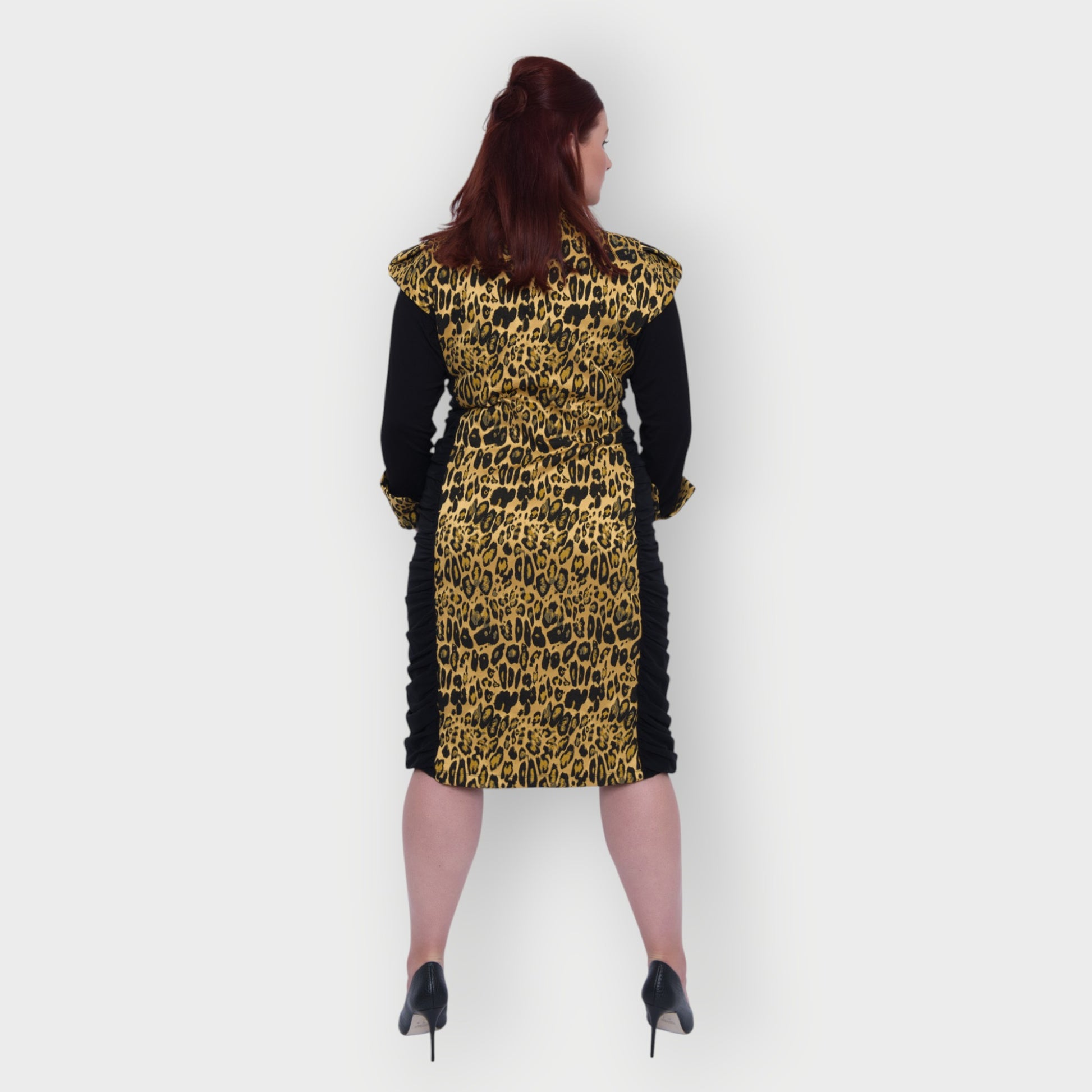 Women's Plus Size Black Gold Bodycon Midi Leopard Brocade Jacquard Dress styled with black heels for an elegant, polished look. White Background.