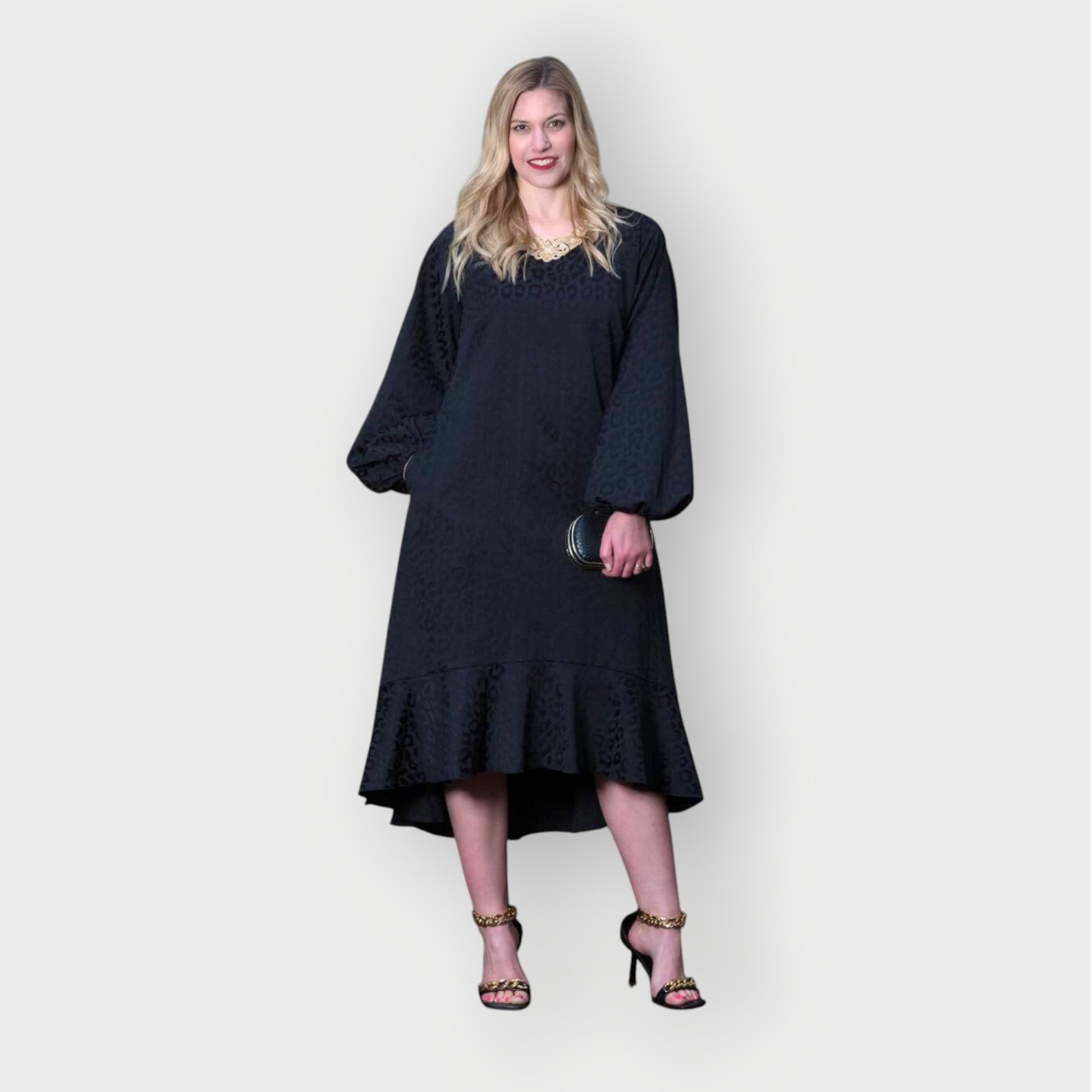 Women's Aphrodite Black Leopard Jacquard Dress styled with a gold necklace, black clutch and gold chain heels for a chic, coordinated look.