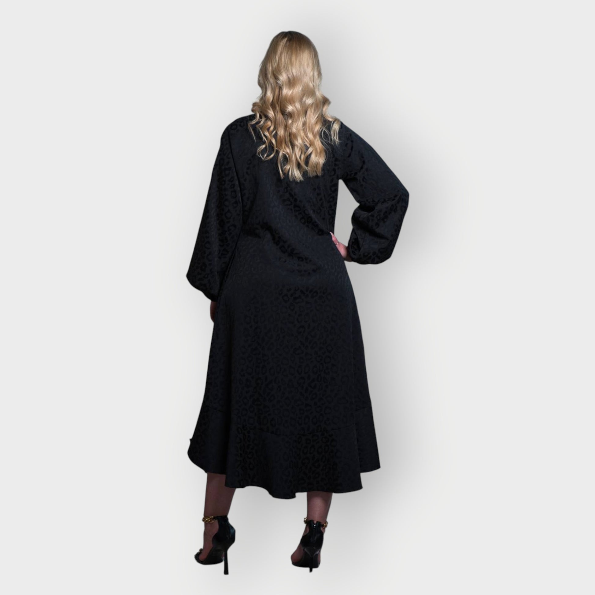 Women's Aphrodite Black Leopard Jacquard Dress styled with gold chain heels for a chic, coordinated look.