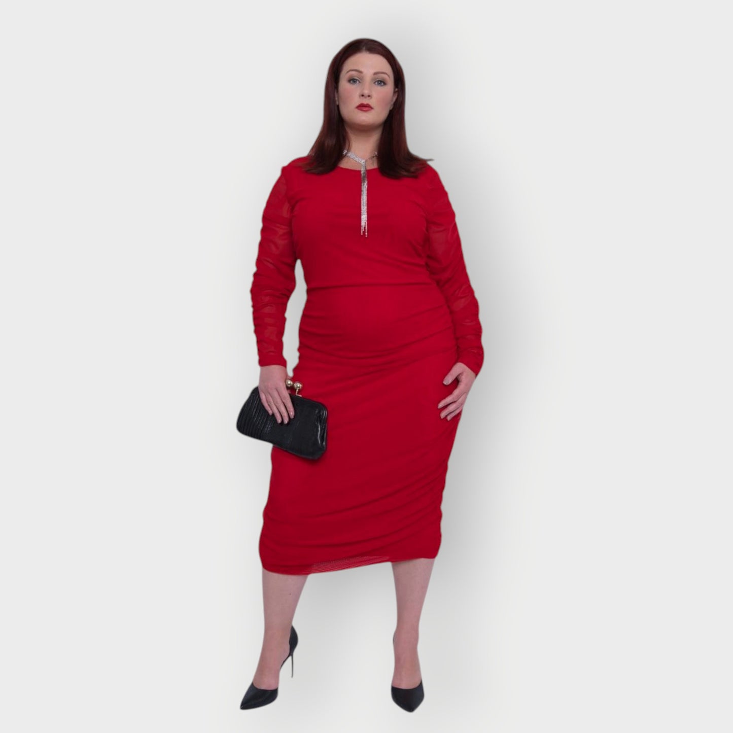 Women's Red Plus Size Boudicca Ruched Bodycon Midi Dress styled with  a black clutch and black heels. White Background