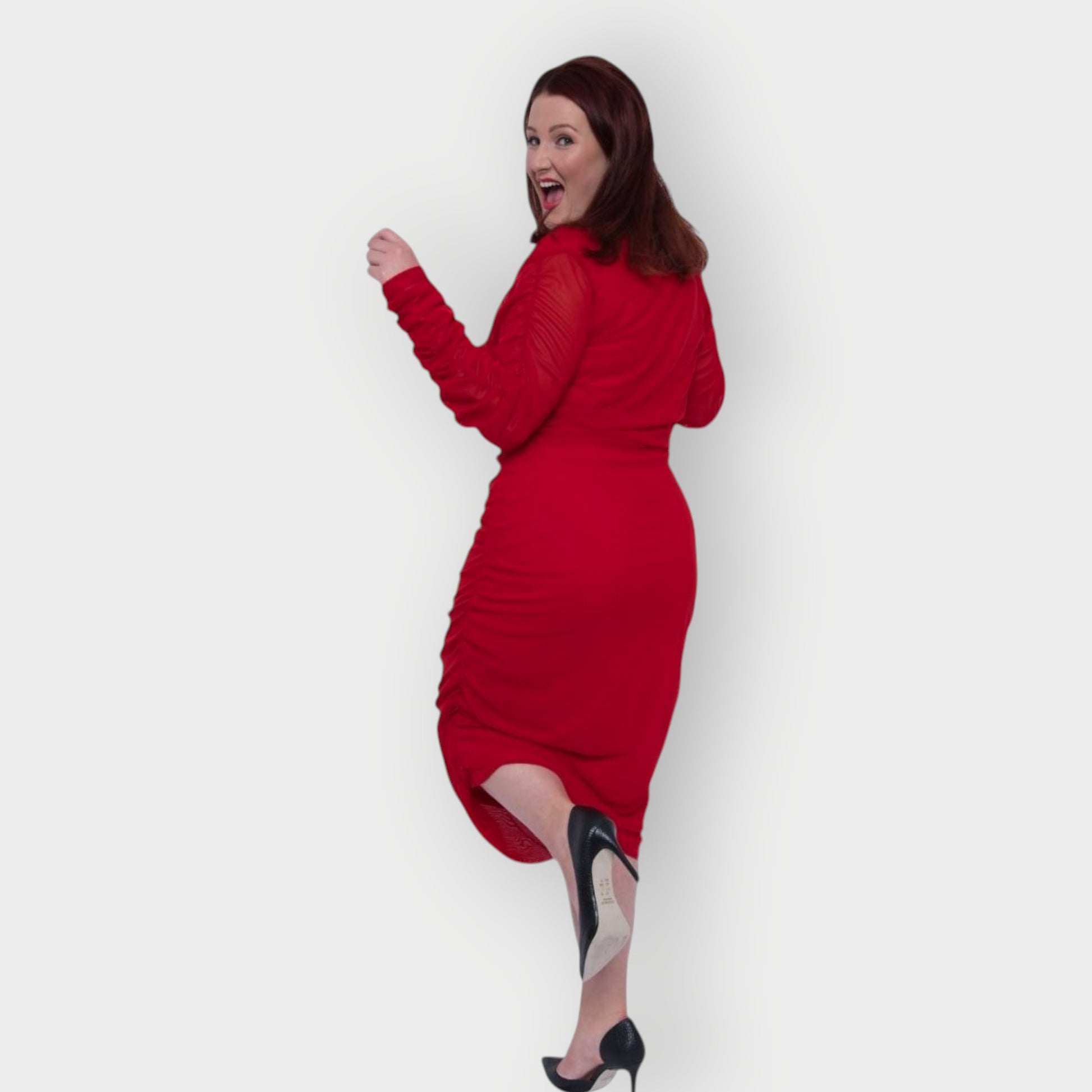 Women's Red Plus Size Boudicca Ruched Bodycon Midi Dress styled with black heels. White Background