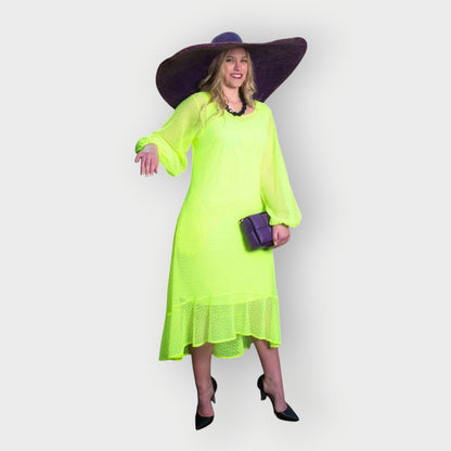 Women's Aphrodite Neon Lime Holiday Resort Dress with matching neon lime undergarment, styled with a purple sunhat, handbag, and black heels.