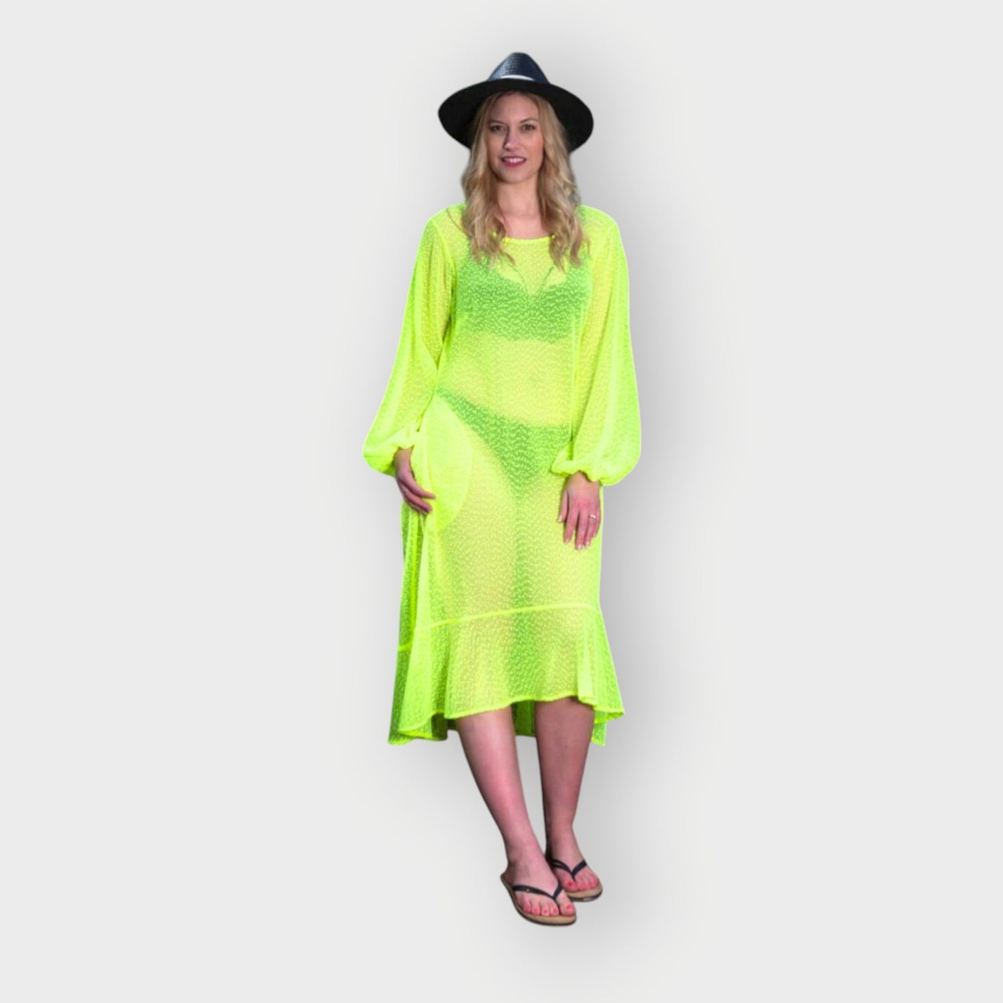 Women's Aphrodite Neon Lime Holiday Resort Dress styled with a bikini underneath, paired with a black hat and black flip-flops for a casual look.