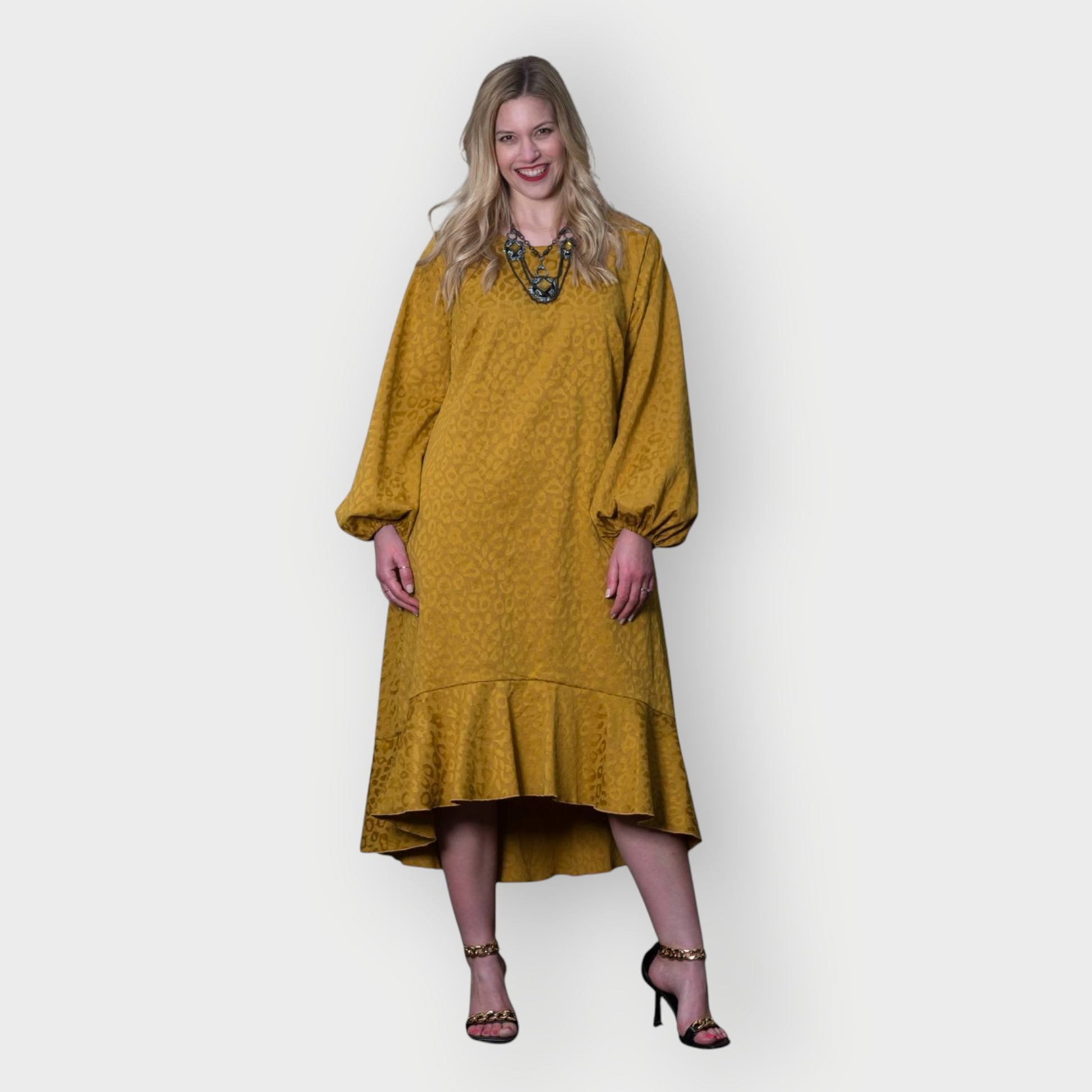 Women's Mid Size Gold Aphrodite Leopard Jacquard Dress styled with a yellow stone necklace and gold chain heels for an elegant look.