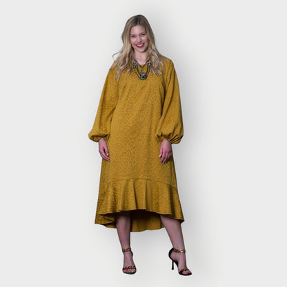 Women's Mid Size Gold Aphrodite Leopard Jacquard Dress styled with a yellow stone necklace and gold chain heels for an elegant look.