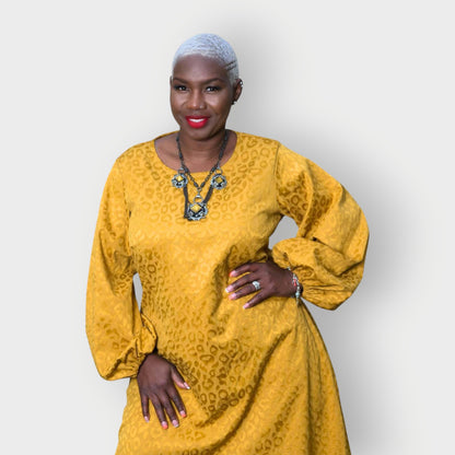 Women's Plus Size Gold Aphrodite Leopard Jacquard Dress shown as a close up, styled with a yellow stone necklace for an elegant look.