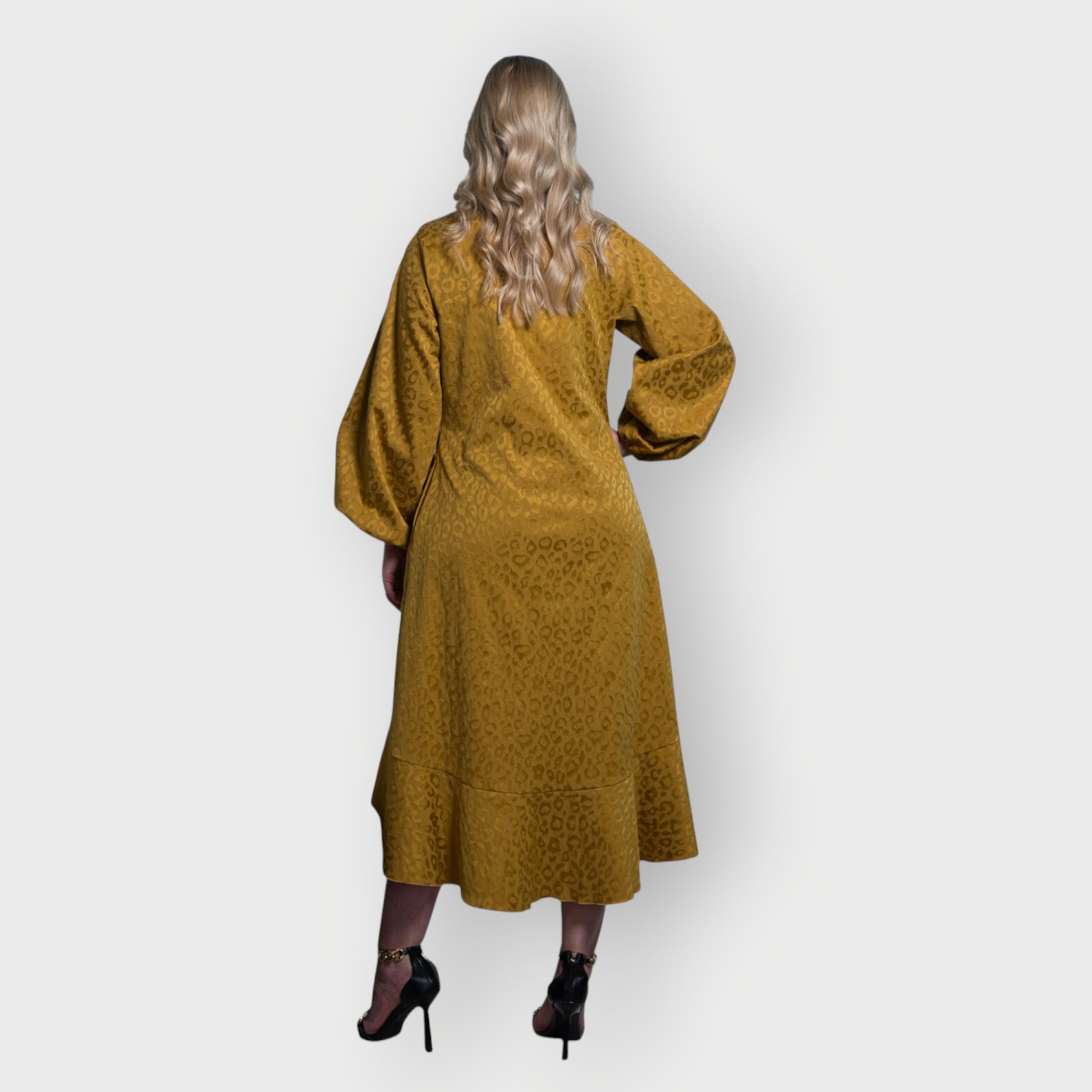 Women's Mid Size Gold Aphrodite Leopard Jacquard Dress styled with a gold chain heels for an elegant look.